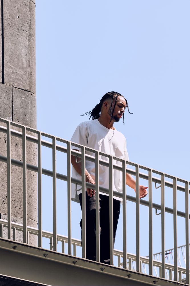Black male standing on bridge